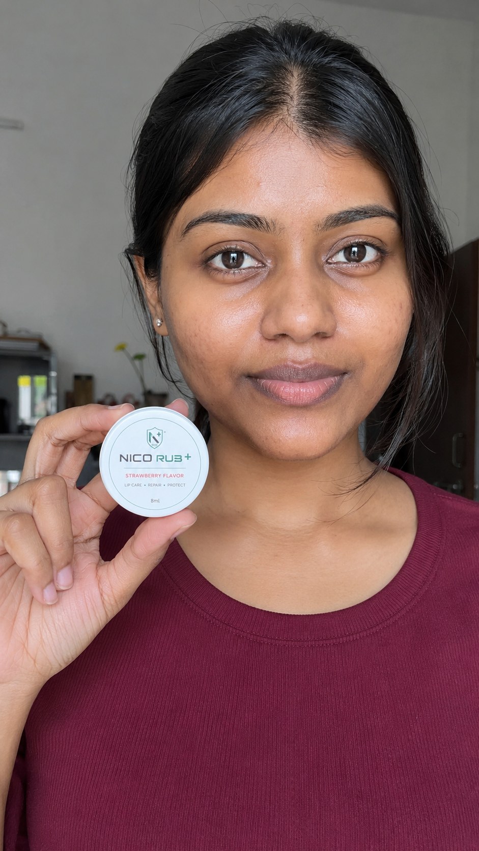 Customer holding the NICO RUB+ Strawberry lip balm